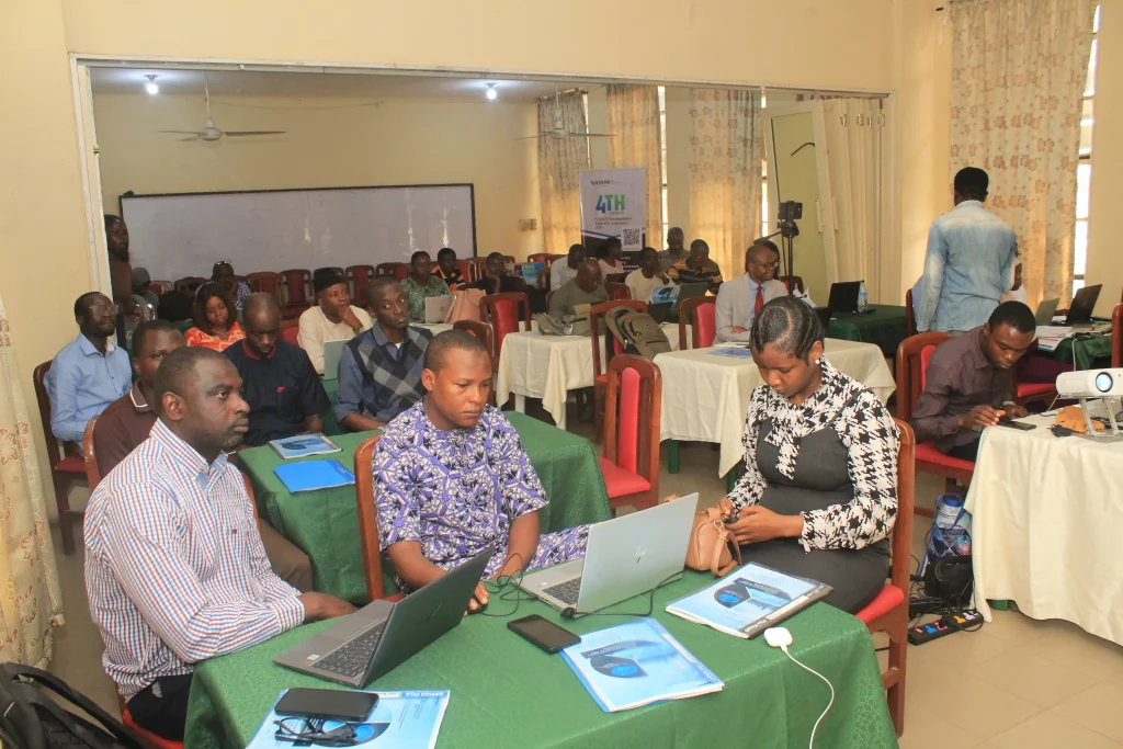 Conference participants working on laptops during a breakout session